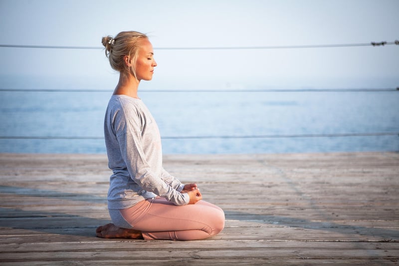 Woman practicing yoga at sunrise